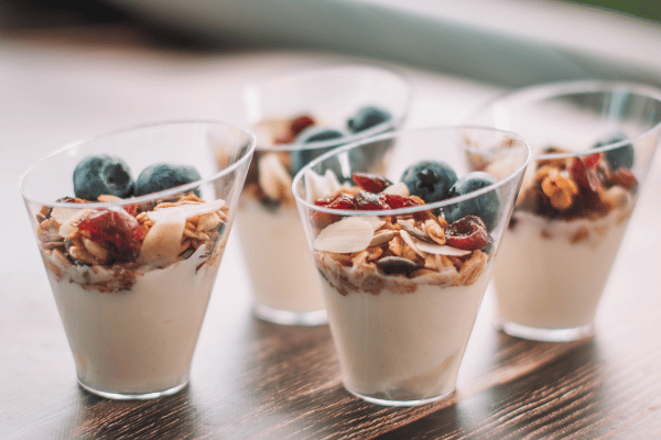 Best Keto Yogurt: Glasses of keto-friendly yogurt topped with a colorful medley of berries and a sprinkle of oats, presenting a delicious and low-carb treat.