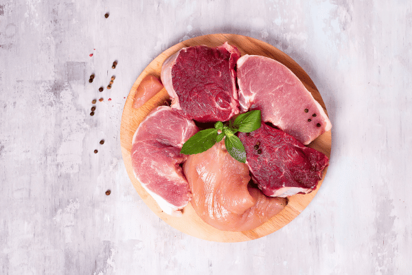 Foods that Burn Fat While You Sleep: Revitalize Your Night 6 Foods that Burn Fat While You Sleep: Different types of meat on a wooden board. Lean proteins.