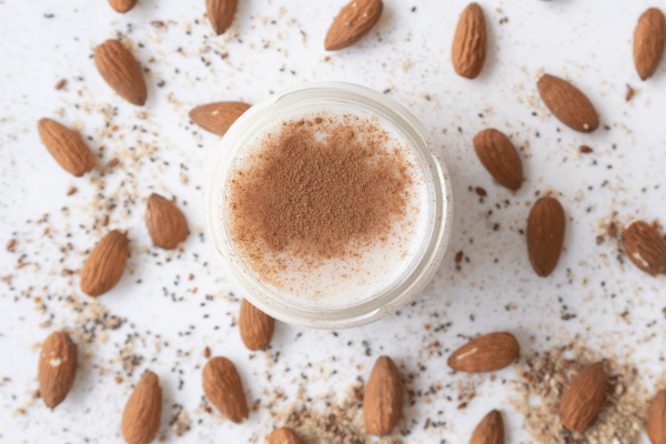 Lowest Carb Almond Milk: Sip Smart With This Keto Delight 8 Lowest Carb Almond Milk: Top view of almond milk with almond powder, capturing the essence of this nutritious and plant-based beverage option.