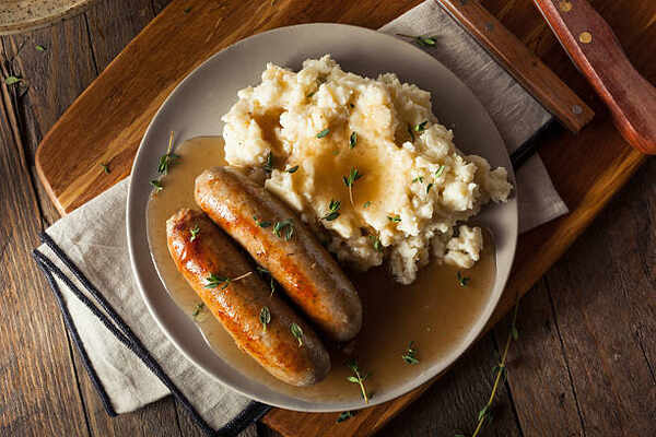 What to Serve with Brats: 10 Irresistible Side Dish Pairings 7 Brats and mashed potatoes with gravy sauce