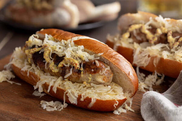 What to Serve with Brats: 10 Irresistible Side Dish Pairings 4 Brats and sauerkraut in buns
