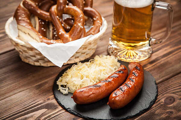 What to Serve with Brats: 10 Irresistible Side Dish Pairings 8 Brats with sauerkraut, German pretzels and a glass of beer