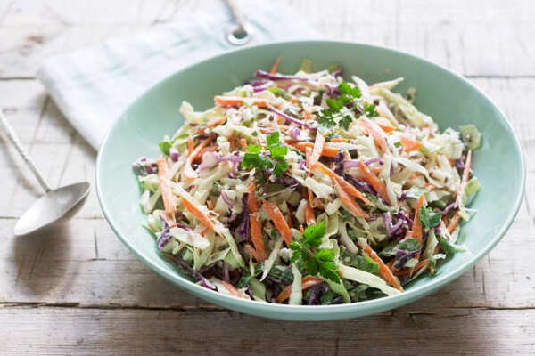What to Serve with Brats: 10 Irresistible Side Dish Pairings 9 A bowl of coleslaw with carrots and cabbages
