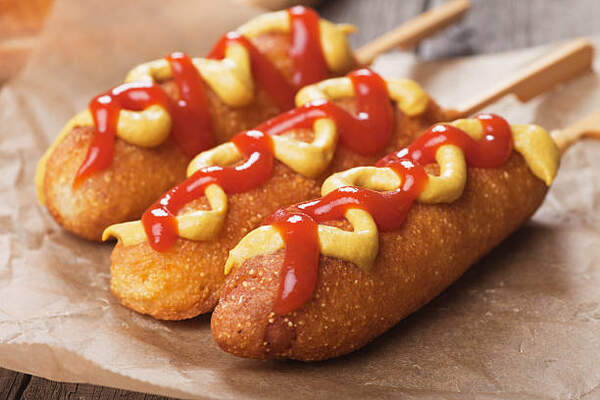 Air Fryer Corn Dogs Delight: Crispy Goodness in Every Bite! 4 Corn dogs on stick with ketchup and mustard