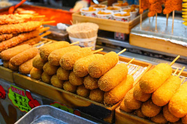 Air Fryer Corn Dogs Delight: Crispy Goodness in Every Bite! 3 Korean corn dogs and other street food in a market