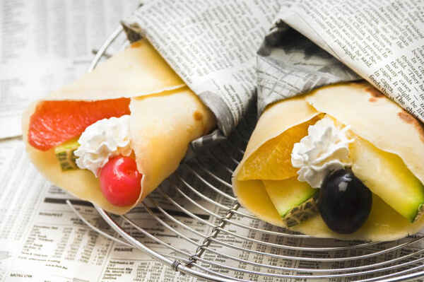 Japanese Crepes: A Mouthwatering Recipe You Can't Miss! 2 Crepes folded into cones and filled with fruits and whipped cream