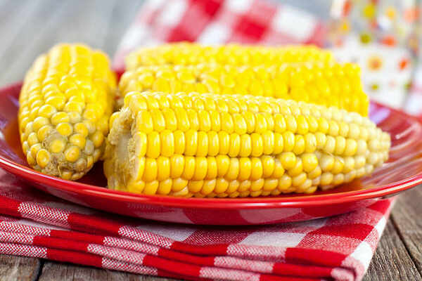 What to Serve with Brats: 10 Irresistible Side Dish Pairings 6 Steamed corn on the cob on a plate