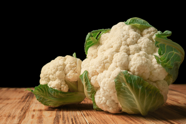 Baked Cauliflower Head Recipes You Must Try at Home 2 Cauliflower Cabbage on Wooden Table.
