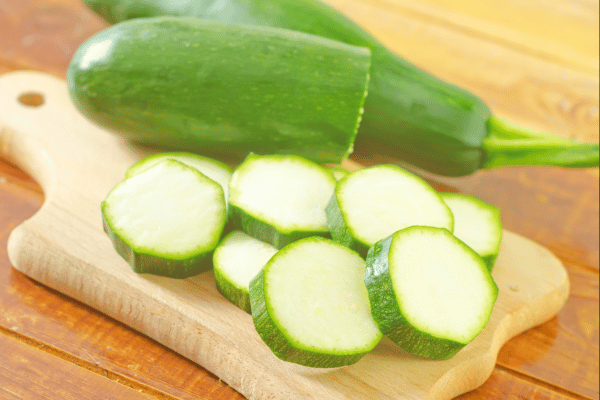 Is Squash Keto: Carbs, Varieties, and Recipes Explained 4 Sliced Zucchini on a Wooden Board as an option on whether is squash keto.