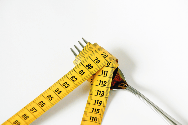 Tape measure wrapped on a fork.