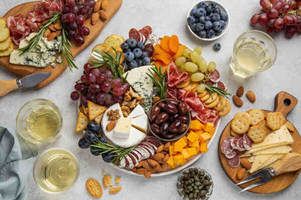 Keto Charcuterie Board Bliss: A Symphony of Low-Carb Taste 3 Charcuterie boards with a variety of meats, cheeses, crackers, nuts, and fruits