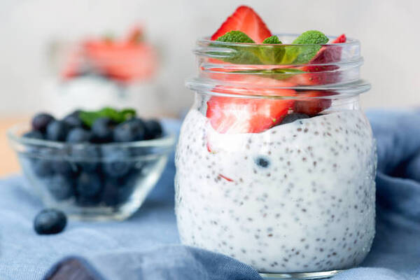 Chia pudding in a jar with strawberries and blueberries