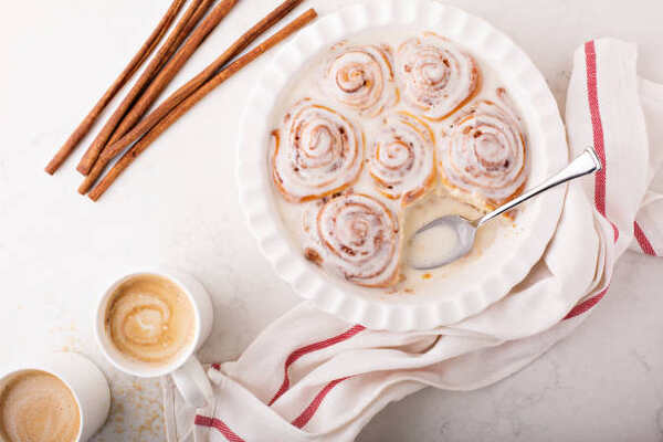 Homemade cinnamon rolls with cups of coffee