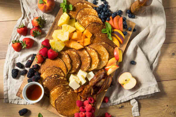 Keto Charcuterie Board Bliss: A Symphony of Low-Carb Taste 12 Breakfast charcuterie board with pancakes bacon and fruits