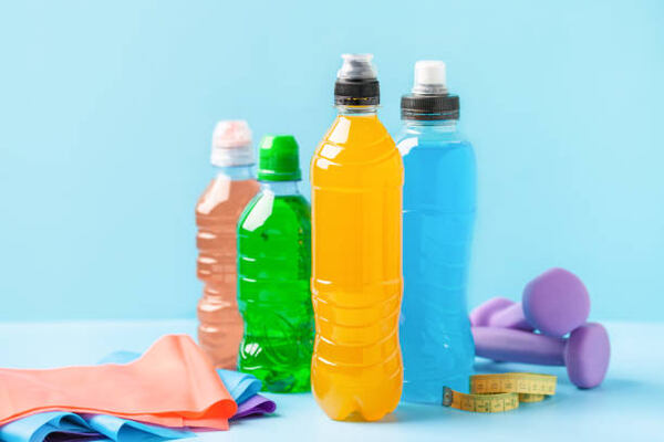 Discover the Best Keto Drink Mix for Weight Loss Success 2 Various sports drinks in bottles with fitness equipment