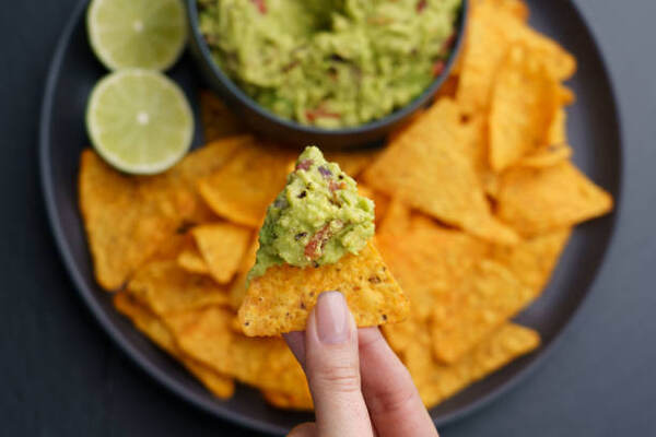 Keto Nachos Recipe: Crunchy Low-Carb Bliss in Every Bite 6 Nacho chips with guacamole dip and limes