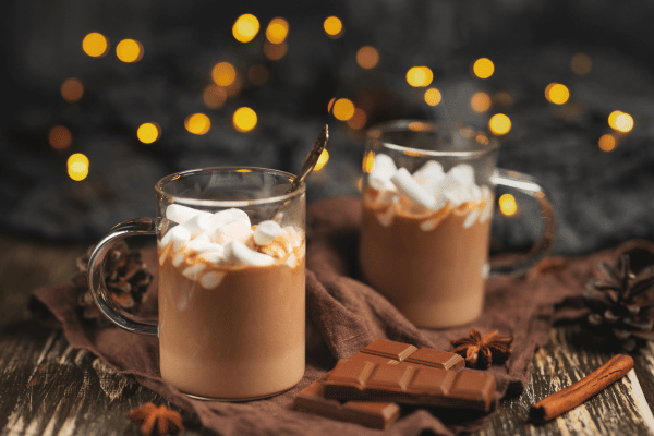 Rich winter hot chocolate with cinnamon sticks and walnuts.