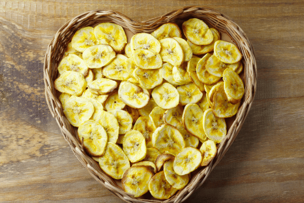 How to Make Plantain Chips at Home for a Nutritional Snack 8 Homemade Dried Banana Chips in Rustic Basket.