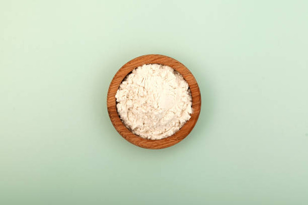 Keto Thickener: Low-Carb Substitutes for Culinary Mastery 10 Guar gum powder in a wooden bowl