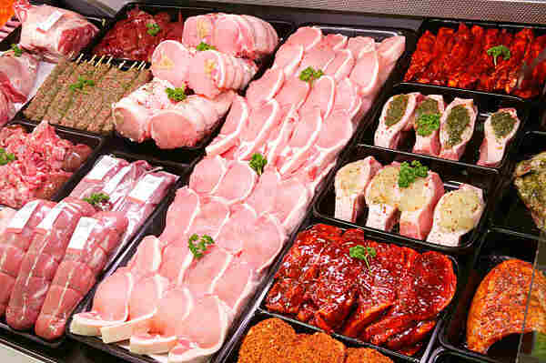 Can You Eat Pork While Pregnant? Master Prenatal Nutrition 2 A variety of pork products on display at a butcher's shop
