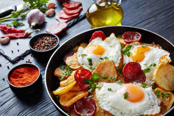 Spanish-style fried eggs with potatoes and sausage