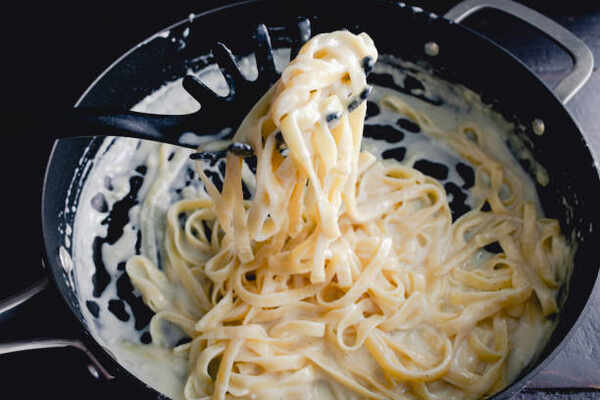 Chicken Alfredo Calories Unveiled: Savor Without Guilt! 4 Cooking fettuccine pasta with alfredo sauce