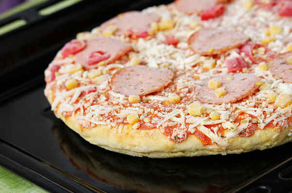 Keto Frozen Pizza: Indulge in Flavorful Crusts Guilt-Free 3 Frozen pizza with salami cheese on a baking sheet