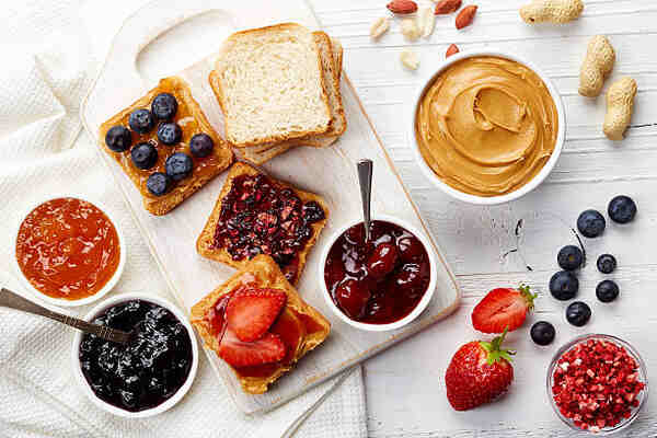 Keto Jelly Recipe: Savor the Sweetness, Skip the Carbs! 8 Bread slices with peanut butter spread and different fruit jellies