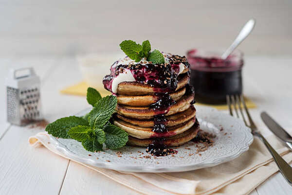 Keto Jelly Recipe: Savor the Sweetness, Skip the Carbs! 9 A stack of pancakes topped with sour cream and blueberry jam