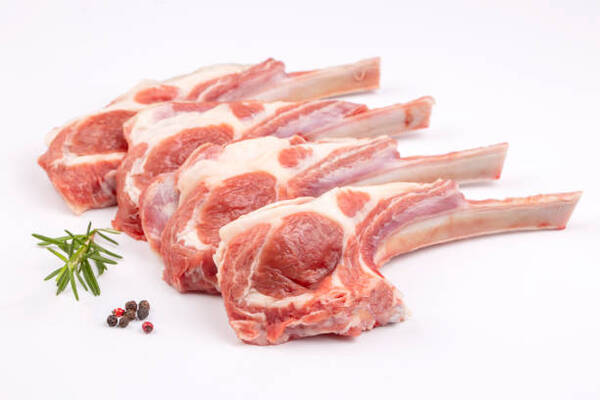 Is Lamb Red Meat? Exploring Its Role in a Balanced Diet 2 Raw lamb chops on a white background