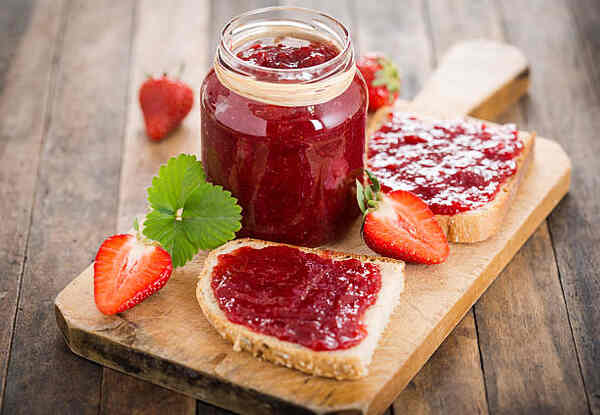 Keto Jelly Recipe: Savor the Sweetness, Skip the Carbs! 2 Homemade strawberry jelly from a jar spread on bread