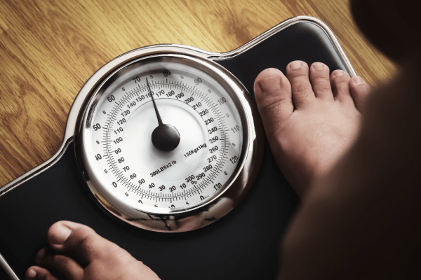 10 Surplus Diet Ideas for a Healthy Lifestyle 10 Man Recording Weight Through Weight Scale.