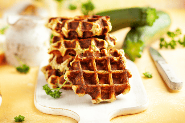 Carbalose Flour: The Ultimate Low-Carb Baking Solution 11 A stack of delicious brown waffles is artfully arranged on a rustic wooden table.