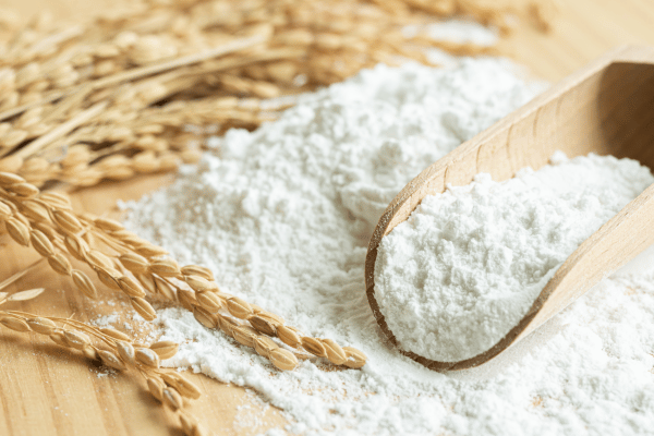 Carbalose Flour: The Ultimate Low-Carb Baking Solution 4 A neatly arranged pile of wheat flour sits atop a rustic wooden table.