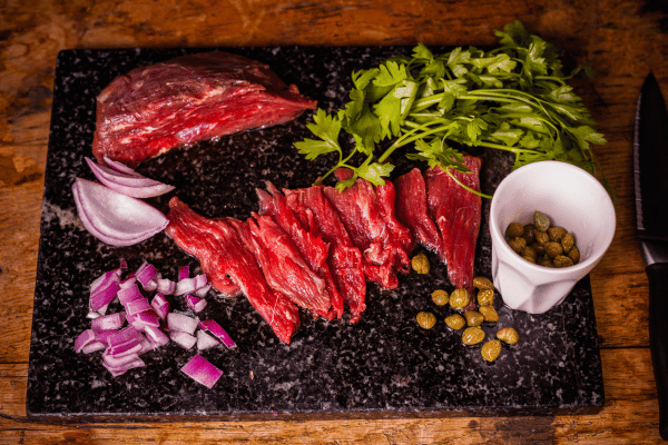 Perfect Steak Tartare: How to Make at Home 7 Steak fillet with beans, herbs, and onions.