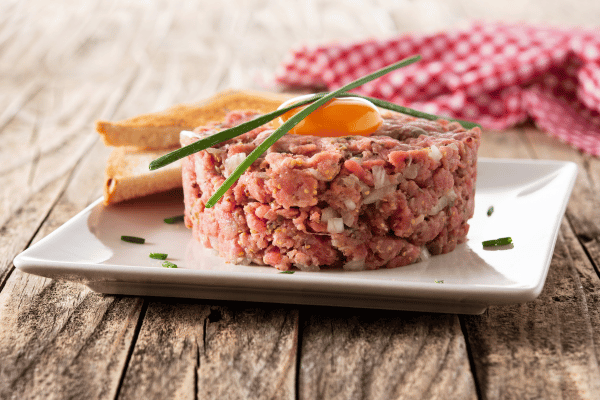 Perfect Steak Tartare: How to Make at Home 8 Toast and delicious steak tartare on a plate.