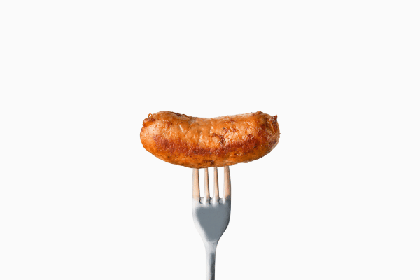 Quick and Easy Chicken Sausage in Air Fryer 4 A close-up shot of a fork piercing a juicy chicken sausage in air fryer.