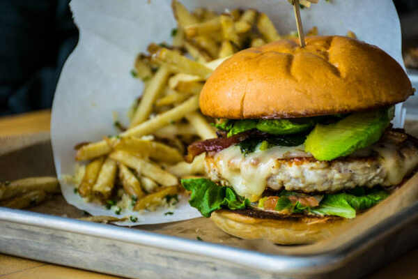 Whataburger Keto: Your Guide to Low-Carb Fast Food Options 5 Burger with avocado and bacon slices with a side of fries