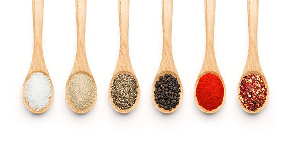 Different spices in wooden spoons
