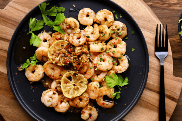 5 Keto Shrimp Recipes: Quick & Easy Dishes You'll Love 11 Keto Shrimp Recipes: Spicy Shrimps on a Plate.