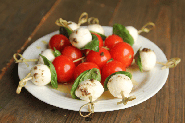 Trader Joe's Cauliflower Thins: Healthy Snack Hacks 12 Caprese Salad Bites on a stick, beautifully arranged.