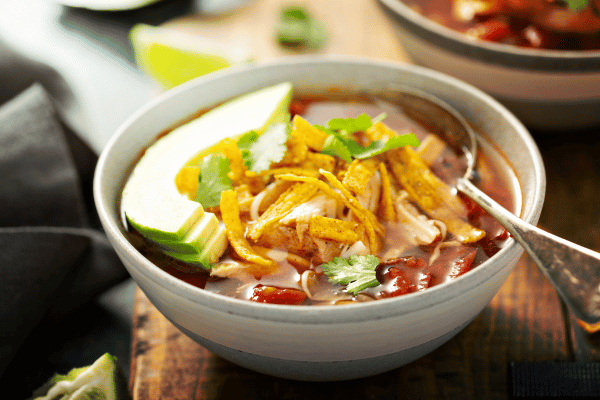 Keto Taco Soup Recipe: The Perfect Low Carb Comfort Food 3 Slow cooker chicken taco soup topped with fresh cilantro and avocado.