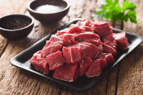 The Best Pork Cube Steak Recipe Using Slow Cooker 3 Fresh raw diced meat on cast iron plate.