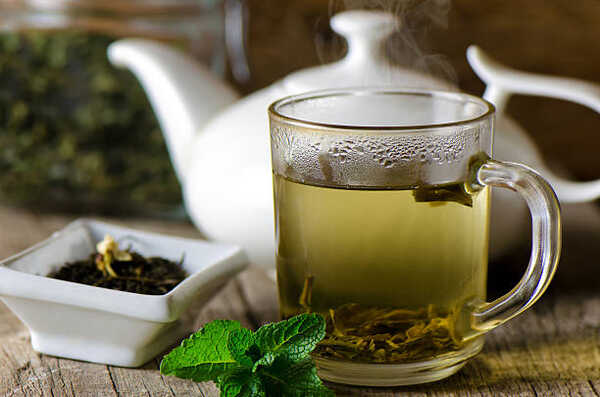 Top Thermic Foods to Boost Your Metabolism Naturally 4 A cup of warm green tea with herbs