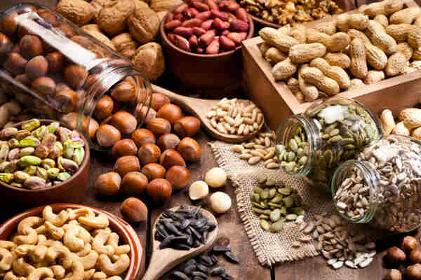 Top Thermic Foods to Boost Your Metabolism Naturally 10 Various nuts and seeds in containers