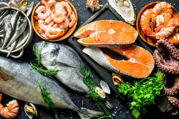 Top Thermic Foods to Boost Your Metabolism Naturally 3 Raw salmon and a variety of seafood