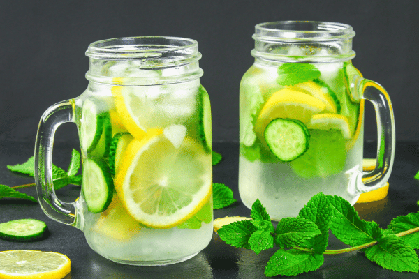 Low Carb Juicing: How to Make Tasty and Healthy Juices 14 Two jars of juice with celery, cucumber, lime, and ginger.