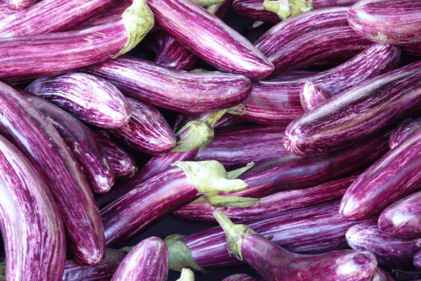How to Make Keto Moussaka: A Step-by-Step Guide 3 A close-up of vibrant, glossy eggplants showcases their rich purple hues and firm texture.