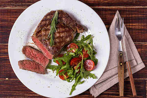 Easy Ribeye Steak Recipe: Delicious and Quick to Make 7 Sliced ribeye steak served with vegetables