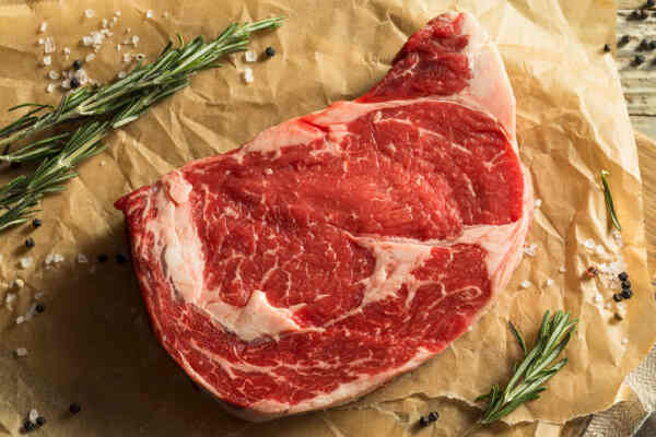 Easy Ribeye Steak Recipe: Delicious and Quick to Make 5 Raw ribeye seasoned with salt and pepper and herbs